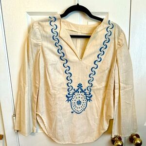 White vintage 1970’s tunic top with blue embroidered collar/chest piece.